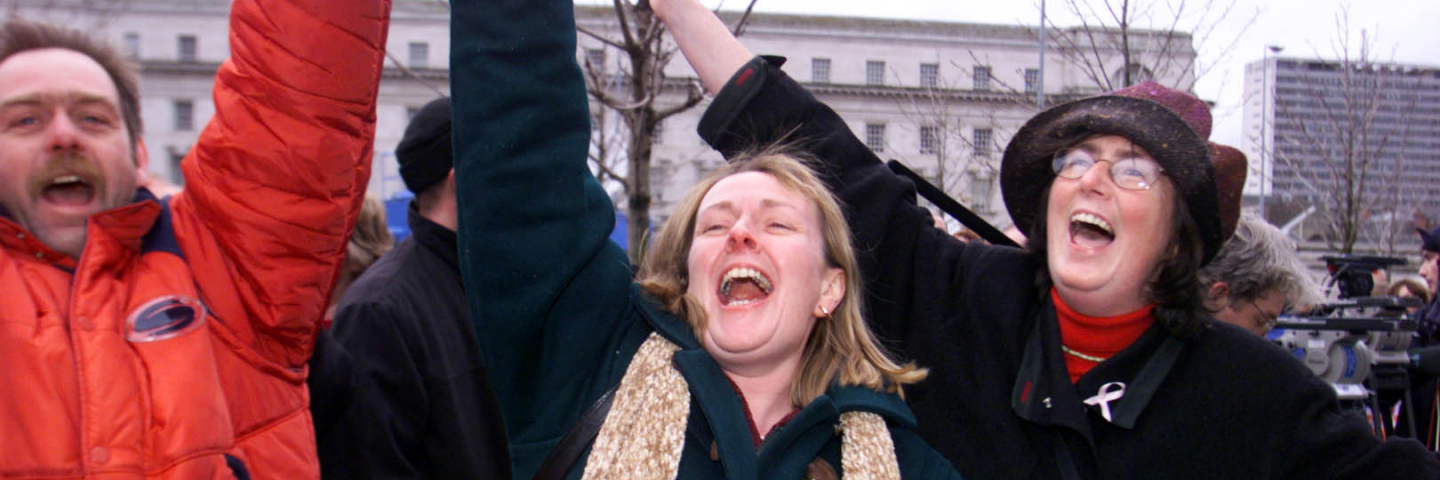 Jubilant Agreement supporters celebrate outside Belfast Waterfront Hall following the meeting of the Ulster Unionist Council. The council voted to back their leader David Trimbe, to enter a power-sharing government with Sinn Fein by 480 votes to 349. * Members of the Ulster Unionists' 858-strong ruling council voted by 480 to 349.