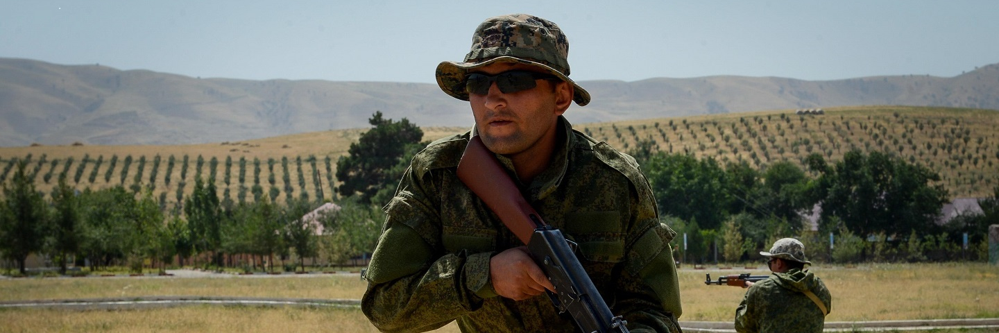 A Tajik service members assumes a defense position during a field training exercise part of multinational exercise Regional Cooperation 2017.