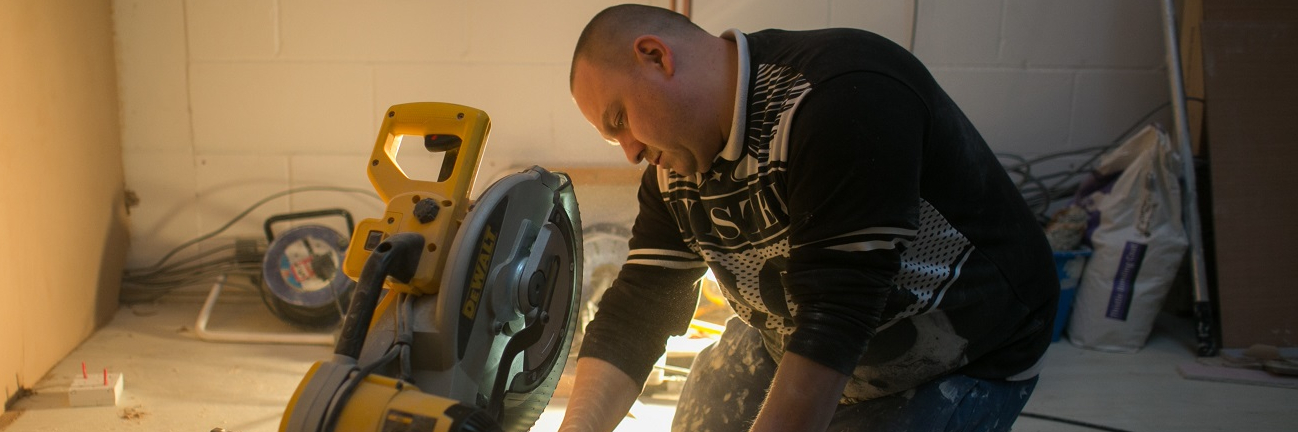 A highly skilled builder from Poland working with construction tools in a flat in London, United Kingdom.