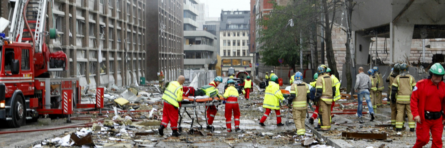 Paramedics and firefighters tend to victims of a bomb blast which took place outside the Norvegian Prime Minister's office in Oslo, on July 22, 2011. The powerful bomb blast rocked government and media buildings in Norway's capital, causing "deaths and injuries" and dealing heavy damage, police said. Police said a bomb was behind the explosion and Norwegian media reported that at least two people died. "A powerful explosion has taken place in the government quarter," Norwegian police said in a statement.