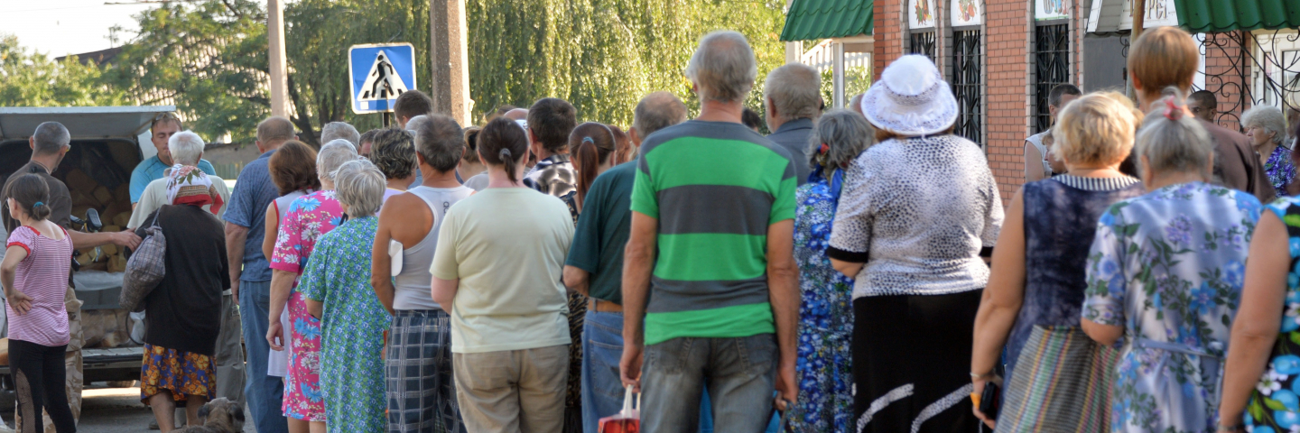 Residents of the eastern Ukrainian city of Lysychansk queue to receive bread distributed as part of humanitarian aid on July 27, 2014. Ukrainian troops have retaken the strategically-important city of Lysychansk in eastern Ukraine, as they press on with their offensive to stamp out a pro-Russian rebellion.