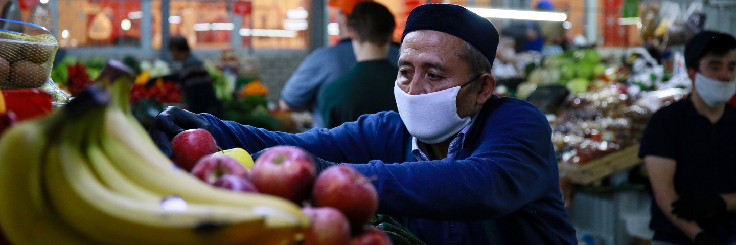 A vendor arranges fruits and vegetables at a market in Almaty on April 25, 2020, amid the coronavirus pandemic.