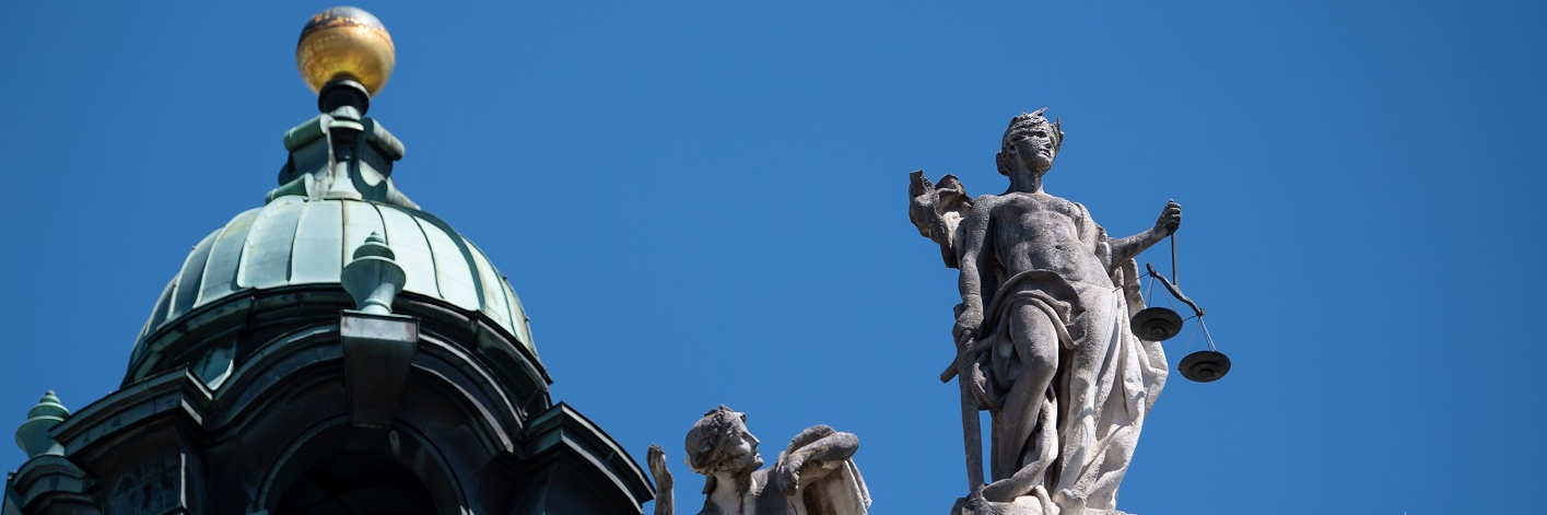 The statue of Justice sits atop the Palace of Justice in Bavaria, Munich.