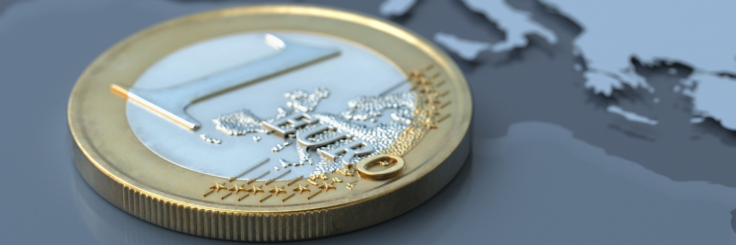 A photo of a Euro coin on a map of Europe.
