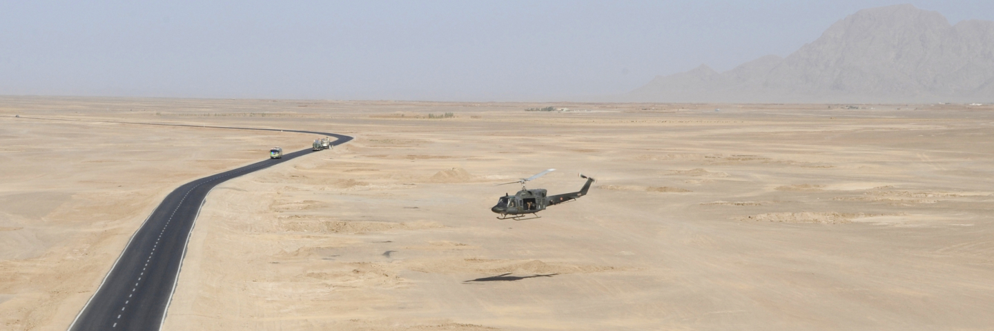 An Italian air force AB-212 helicopter flies over Afghanistan's Ring Road in Farah province during an International Security Assistance Force (ISAF) mission, Oct. 6, 2008.