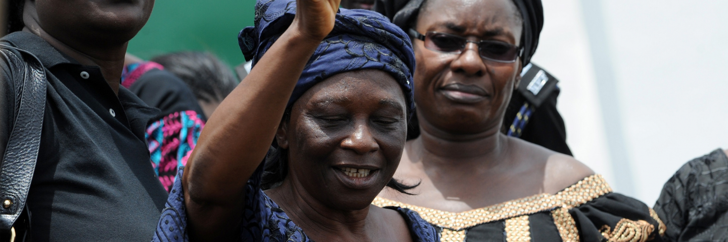 The leader of the Christian Association of Nigeria women in Jos, Mrs Agwu (C), is flanked by Pastor Esther Ibanga (L) and Deputy Governor Paulyn Tallen, as she prays for the women protesting at the government house in Jos, Plateau State, on March 11, 2010. Over 10,000 women marched through the streets of Jos in black wears to the state House of Assembly and later to the government house to protest the killings of women and children at Dogo Nahawa village in Jost south, Plateau State.