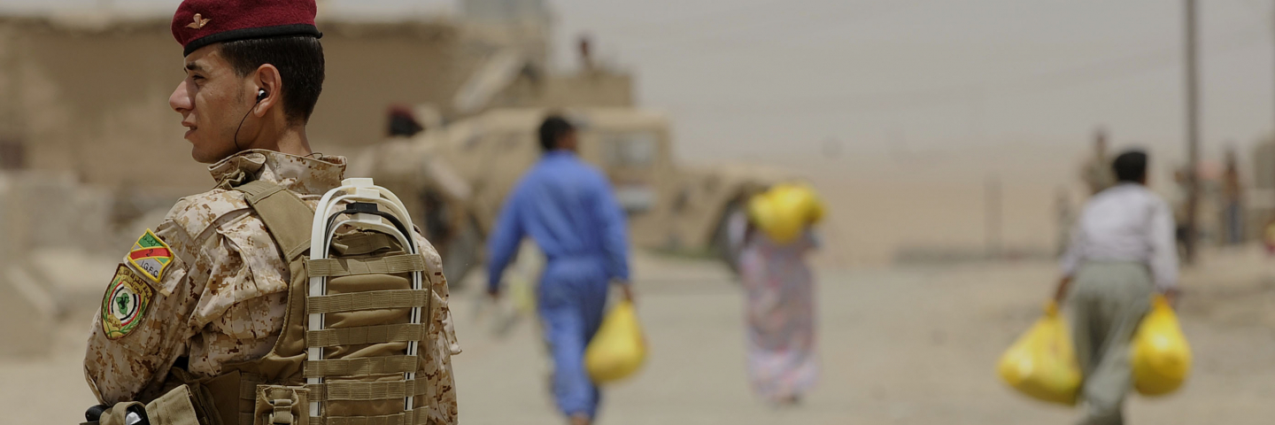 An Iraqi soldier maintains security during a humanitarian aid food drop in the Al Qasr District of Mosul, Iraq, June 10. Iraqi soldiers distributed more than 400 bags of food to residents in the Al Qasr neighborhood.