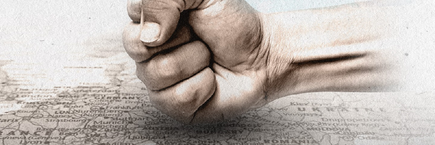 Image of a fist holding a Hungarian flag.