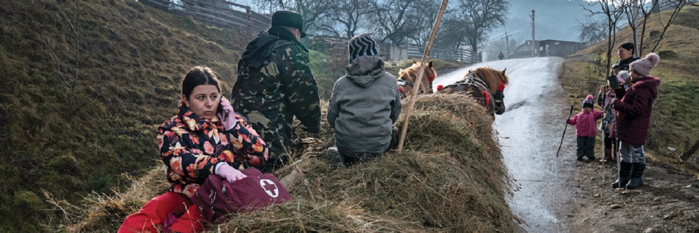 Dr. Viktoria Mahnych rides in the back of a horse-driven cart on her way to visit COVID-19 patients in the village of Verhovyna in western Ukraine in January 2021.
