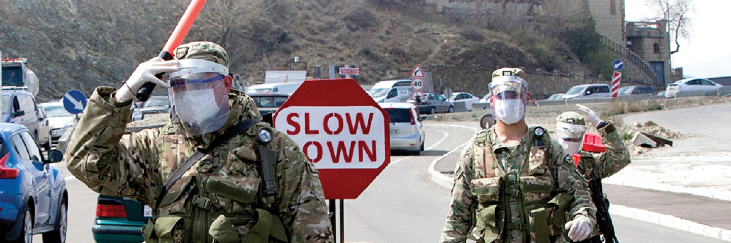 Soldiers in face masks and face shields and gloves