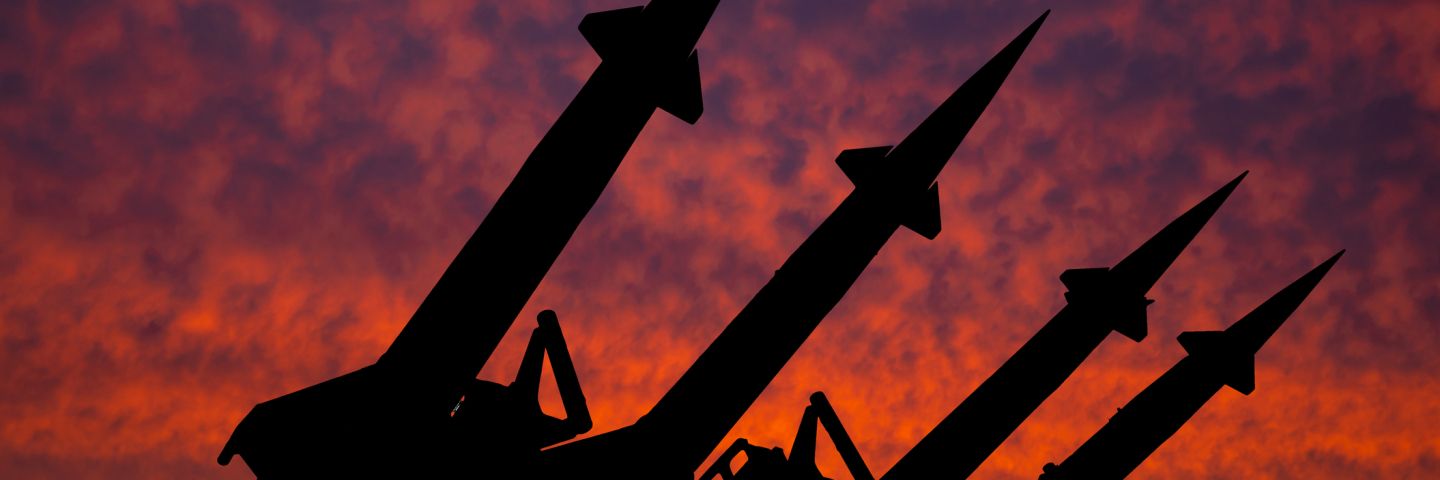 Silhouette of missiles against the setting sun