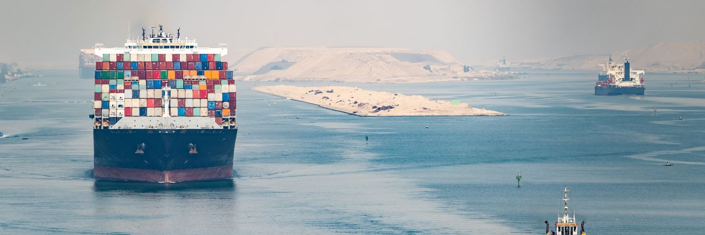 Huge cargo ships navigate through Suez Canal.