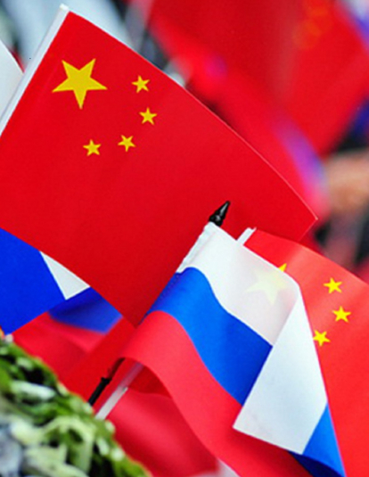 Russian and Chinese flags are flying.