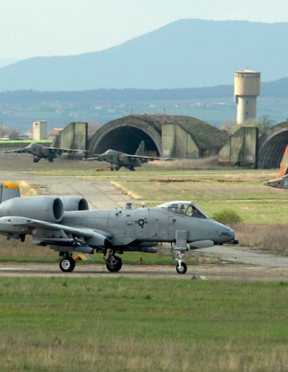 BEZMER AIR BASE, Bulgaria -- An 81st Fighter Squadron A-10 "Warthog" taxis down the runway to take off on a training mission with Bulgarian SU-25s parked in the background at Bezmer Air Base, Bulgaria. The Spangdahlem A-10s deployed here to support Reunion April 2009, a U.S. and Bulgarian Air Forces joint training exercise, August 26,2011. (DOD photo by Air Force Master Sgt. Bill Gomez)