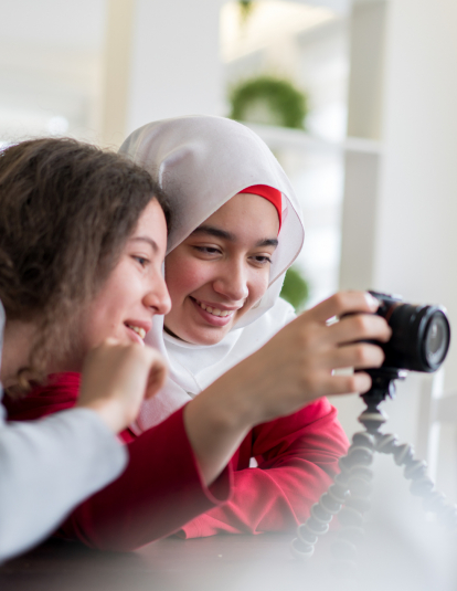 A photograph of two young girls looking a at a camera.