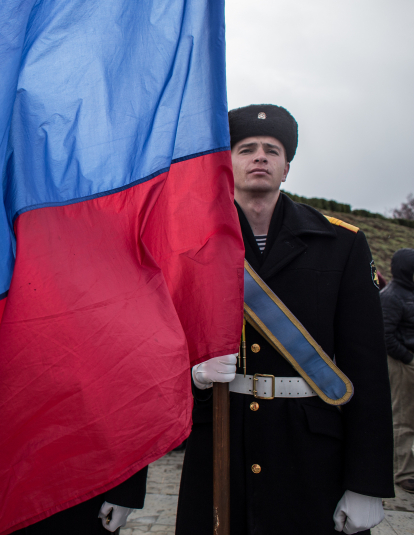 A Navy sailor holds a Russian flag as people celebrate the first anniversary of the signing of the decree on the annexation of the Crimea by the Russian Federation, on March 18, 2015 in Sevastopol, Crimea. 