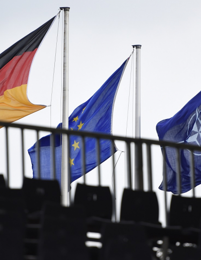 The Flags of Germany, the European Union and the NATO (North Atlantic Treaty Organization) hang during a military exercise on October 10, 2017 near Munster, Germany.