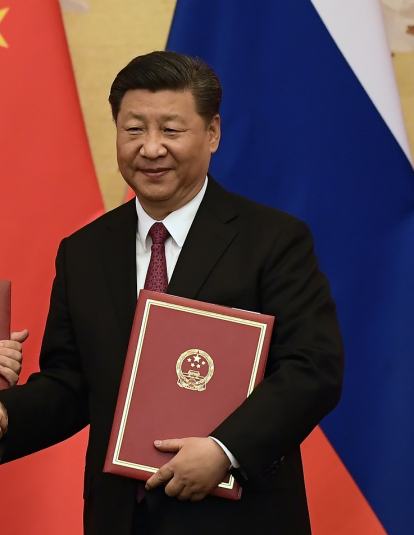A photograph of Chinese President Xi Jinping congratulating Russian President Vladimir Putin after presenting him with the Friendship Medal in the Great Hall of the People on June 8, 2018 in Beijing, China.