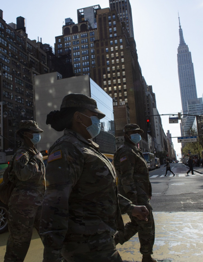 NEW YORK, NY - APRIL 06: U.S Army personnel wearing masks cross 34th street on April 6, 2020 in New York City. The COVID-19 death toll in the U.S. is approaching 10,000.