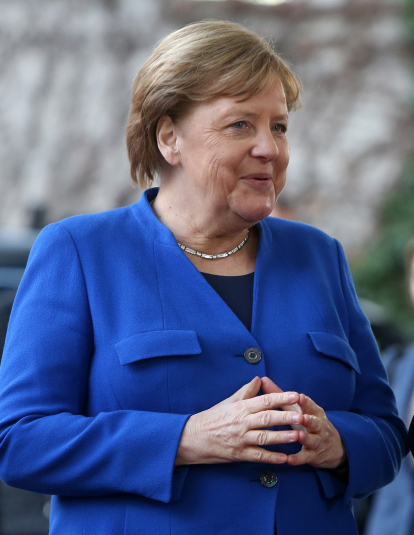 A photograph of German Chancellor Angela Merkel (CDU, L) greets Russian President Vladimir Putin as he arrives for an international summit on securing peace in Libya at the German federal Chancellery on January 19, 2020 in Berlin, Germany. Leaders of nations and organizations linked to the current conflict are meeting to discuss measures towards reaching a consensus between the warring sides and ending hostilities.