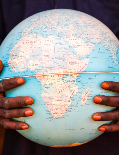 hands holding globe with Africa centered
