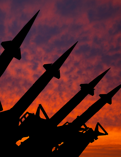 Silhouette of missiles against the setting sun