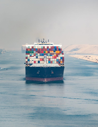 Huge cargo ships navigate through Suez Canal.