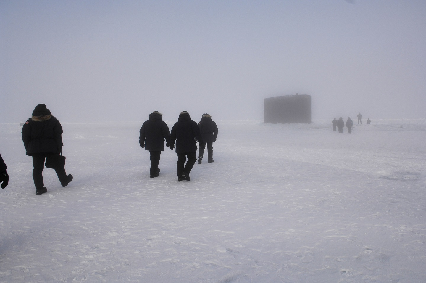 Fog combined with a white-out created from helicopter prop wash partially conceals USS Alexandria's (SSN 757) sail.