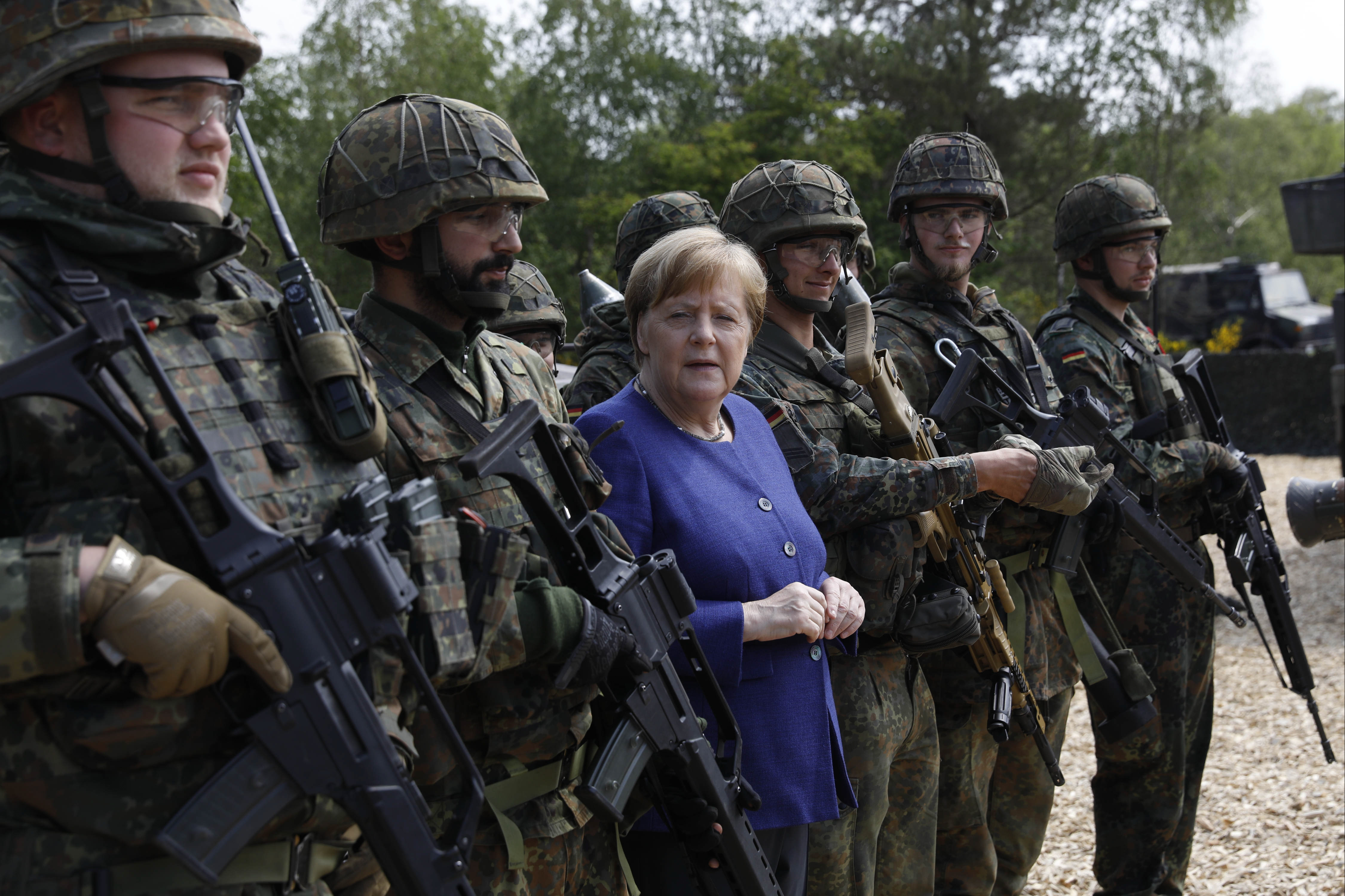 MUNSTER, GERMANY - MAY 20: German Chancellor Angela Merkel poses with members of the Bundeswehr Panzerlehrbrigade 9 (9th Armoured Demonstration Brigade) during a presentation of capabilities by the unit on May 20, 2019 in Munster, Germany. 