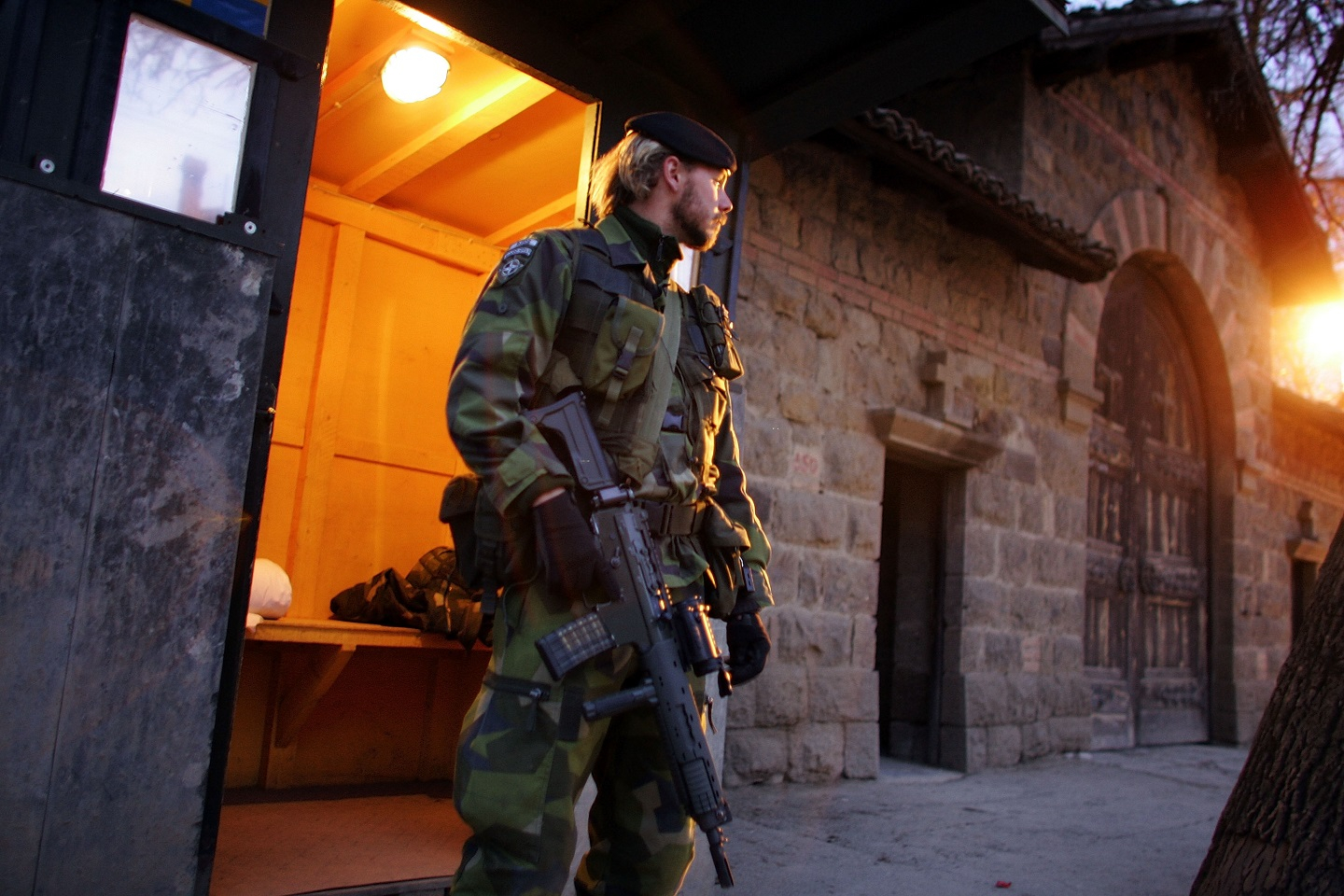 A photograph of a Swedish Kosovo Force (KFOR) soldier.