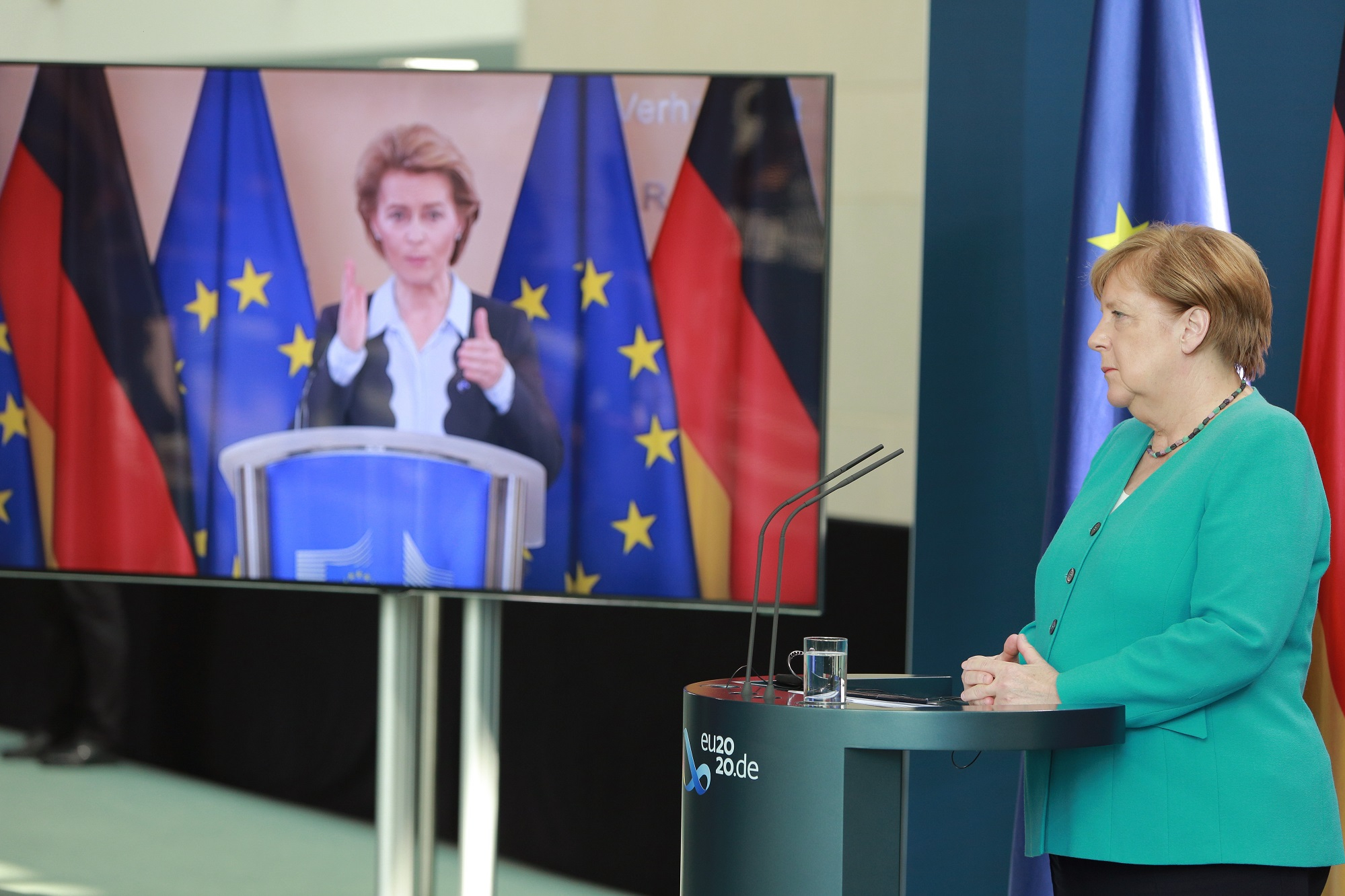 A photograph of  German Chancellor Angela Merkel and European Commission President Ursula von der Leyen (via live video transmission) speak to the media following talks at the Chancellery on July 2, 2020 in Berlin, Germany. 