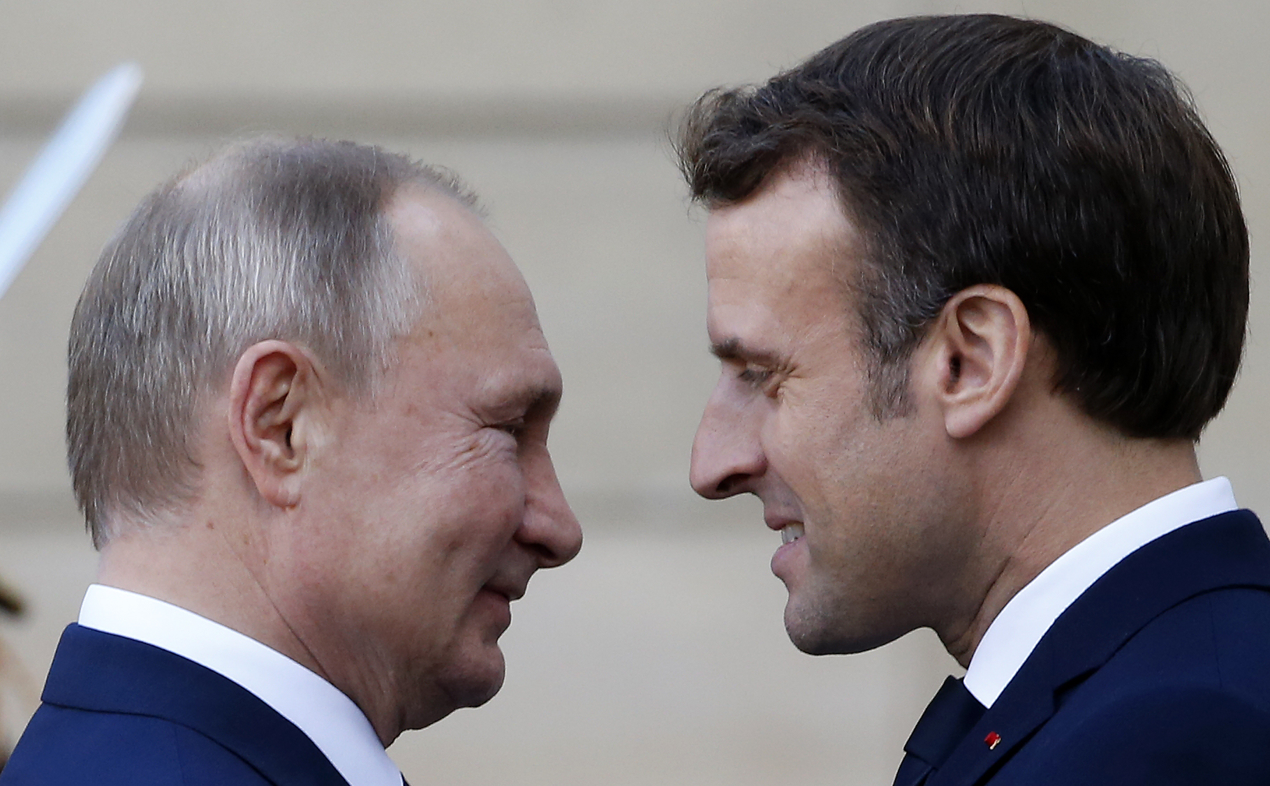 A photograph of French President Emmanuel Macron welcoming Russian President, Vladimir Putin as he arrives at the Elysee Presidential Palace to attend a summit on Ukraine on December 09, 2019 in Paris, France. 