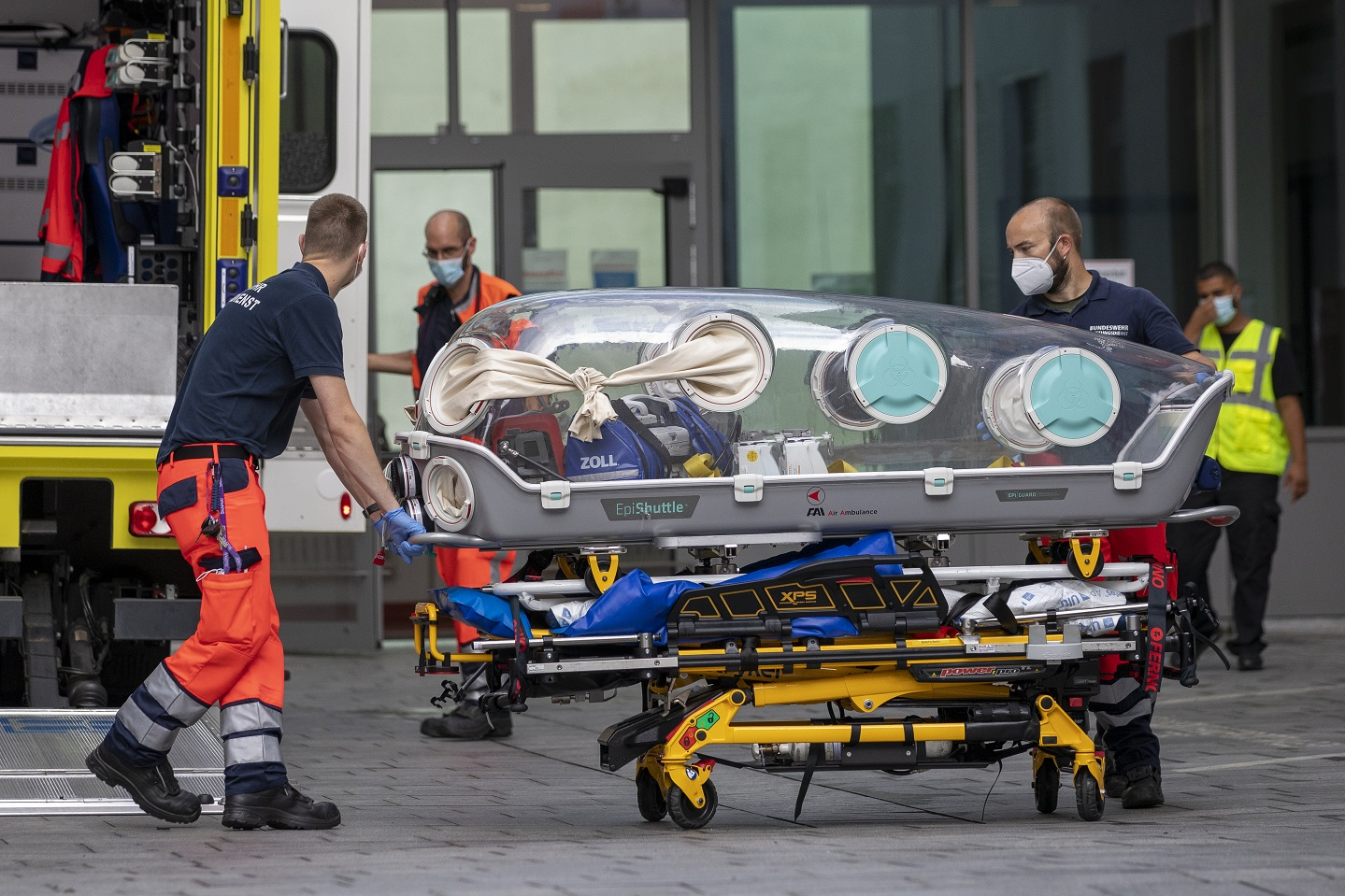 German army emergency personnel load portable isolation unit (Epi Shuttle) into their ambulance that was used to transport Russian opposition figure Alexei Navalny at Charite hospital on August 22, 2020 in Berlin, Germany.