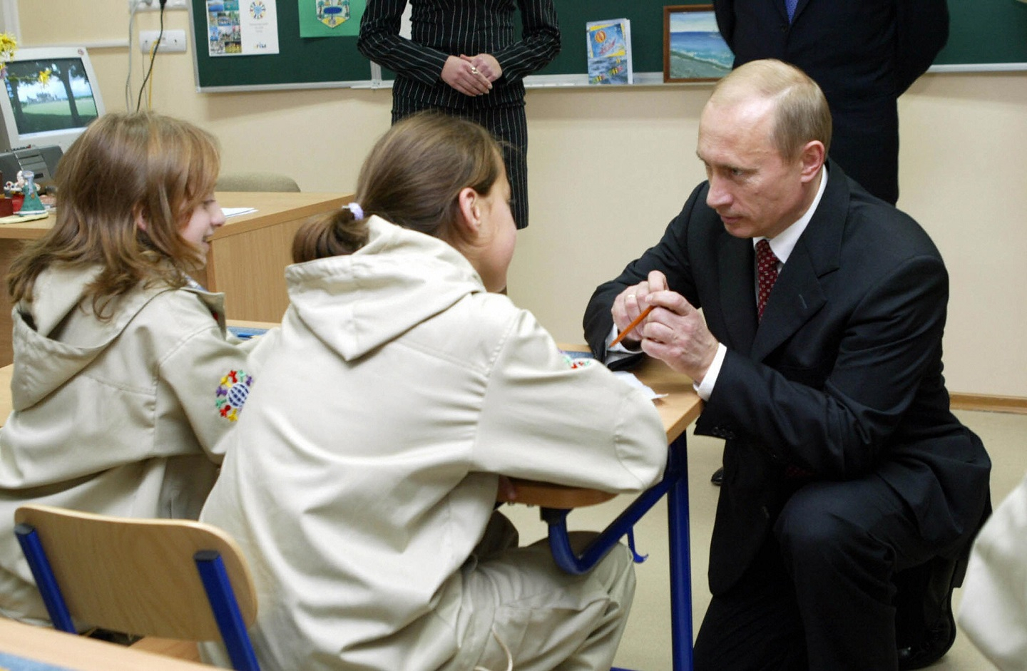 Russian President Vladimir Putin signs autographs for children from Beslan during his visit to the Artek, youth recreation resort near Yalta in Ukraine's Crimea, 12 November 2004.