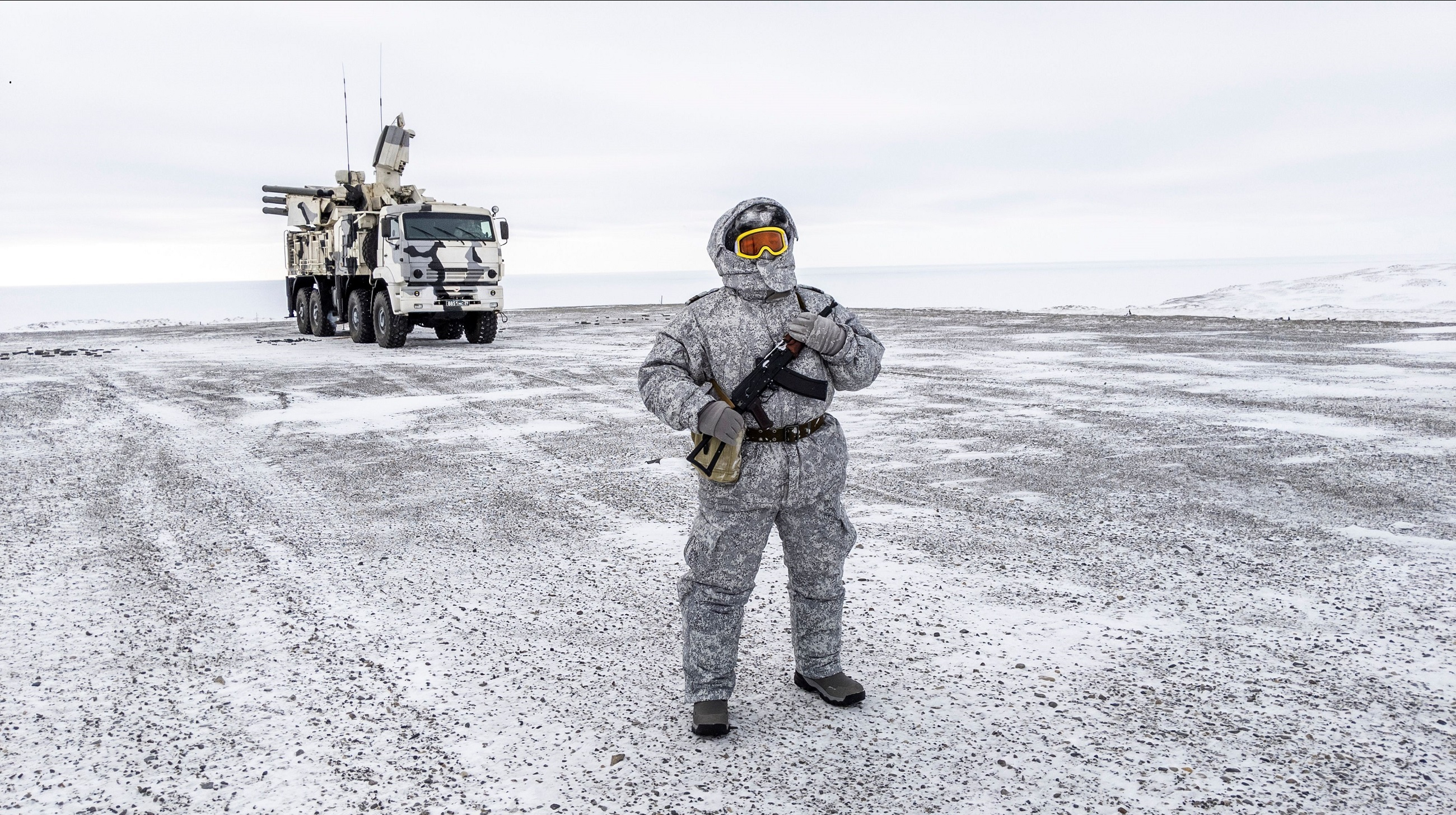 A soldier holds a machine gun as he patrols the Russian northern military base on Kotelny island, beyond the Artic circle on April 3, 2019.