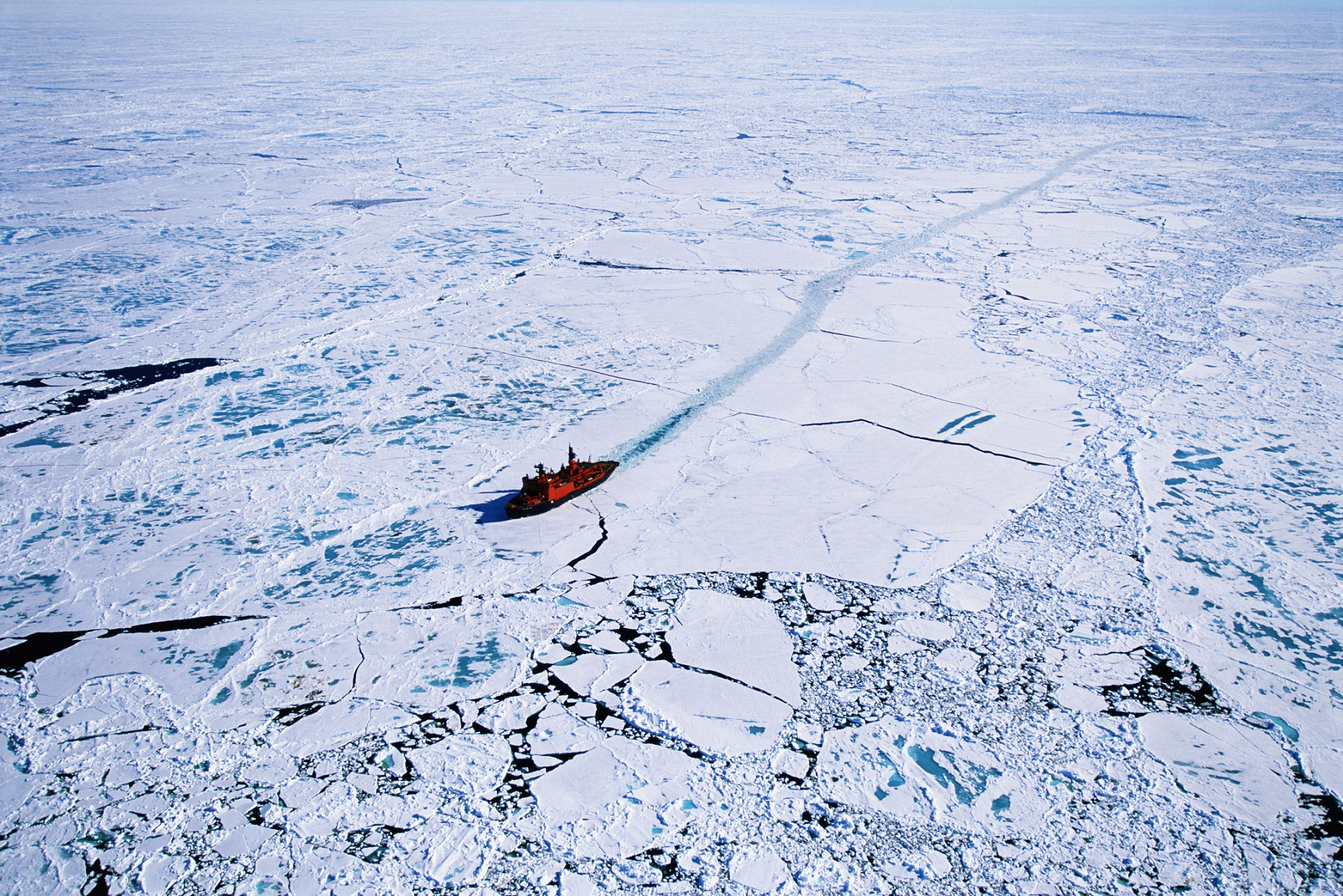 Russian nuclear icebreaker clearing a path to North Pole, aerial view.