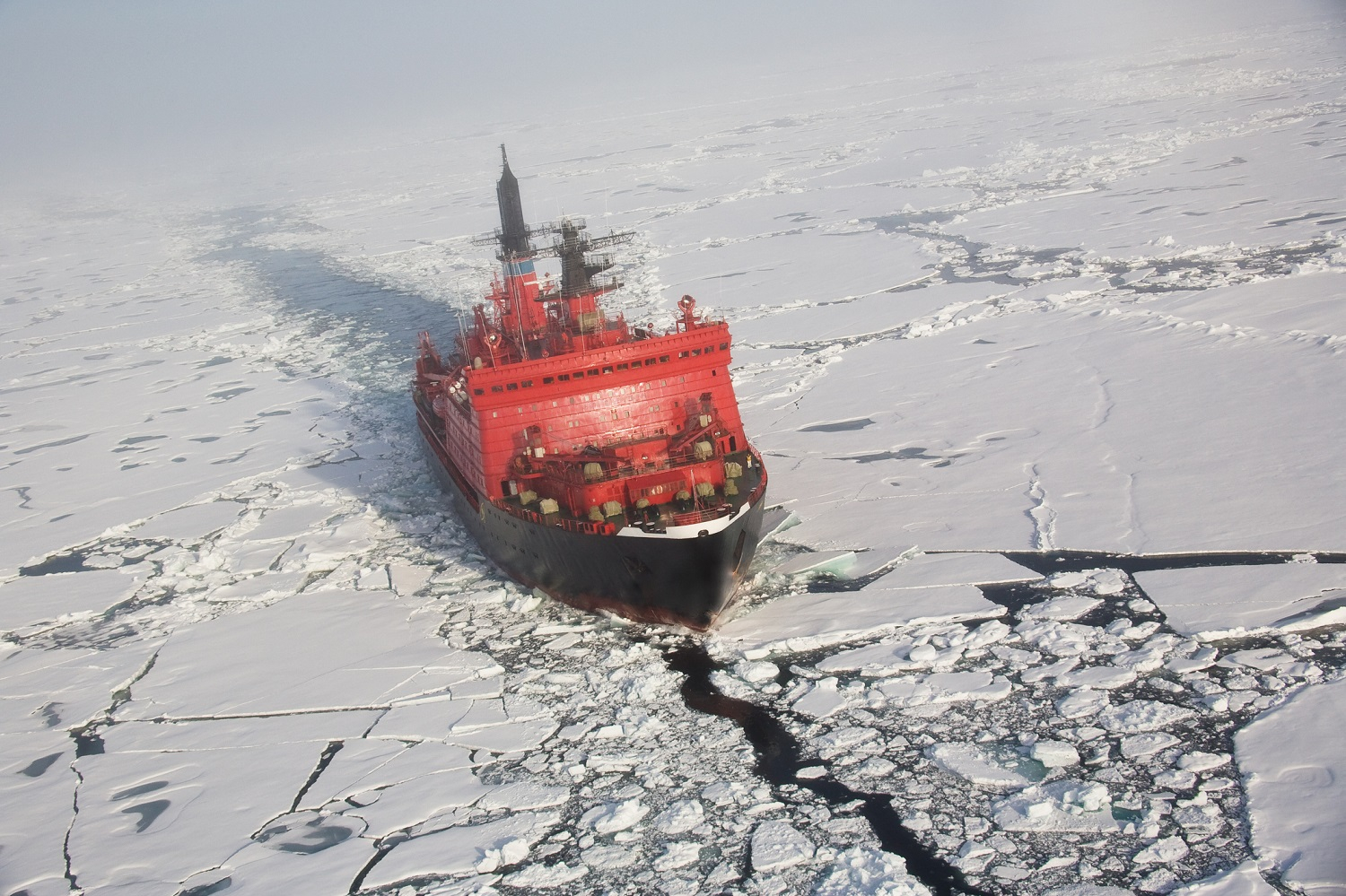 An aerial shot from a helicopter of a Russian nuclear ice breaker heading to the North pole through pack ice.