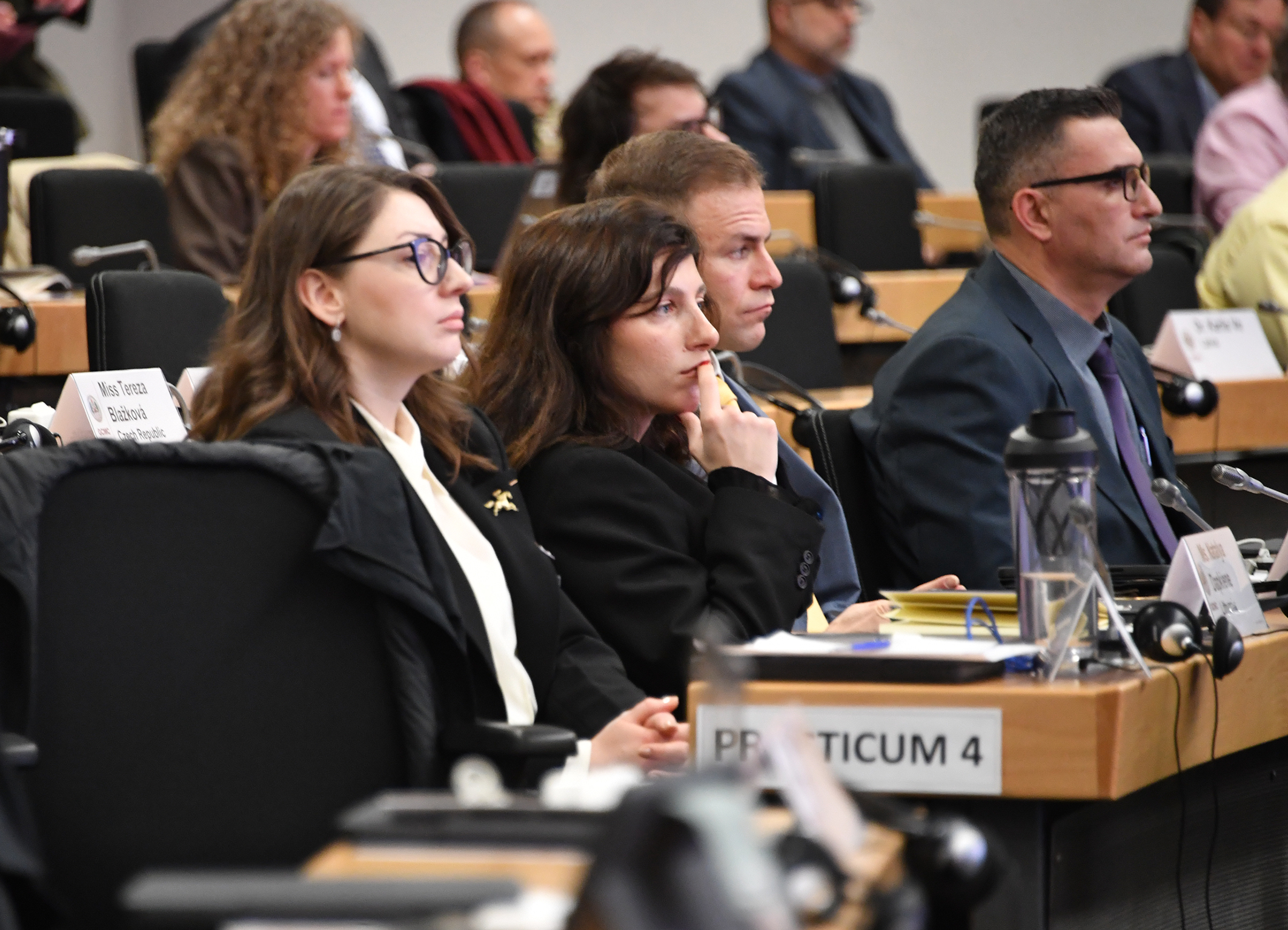 Course participants listen in plenary.