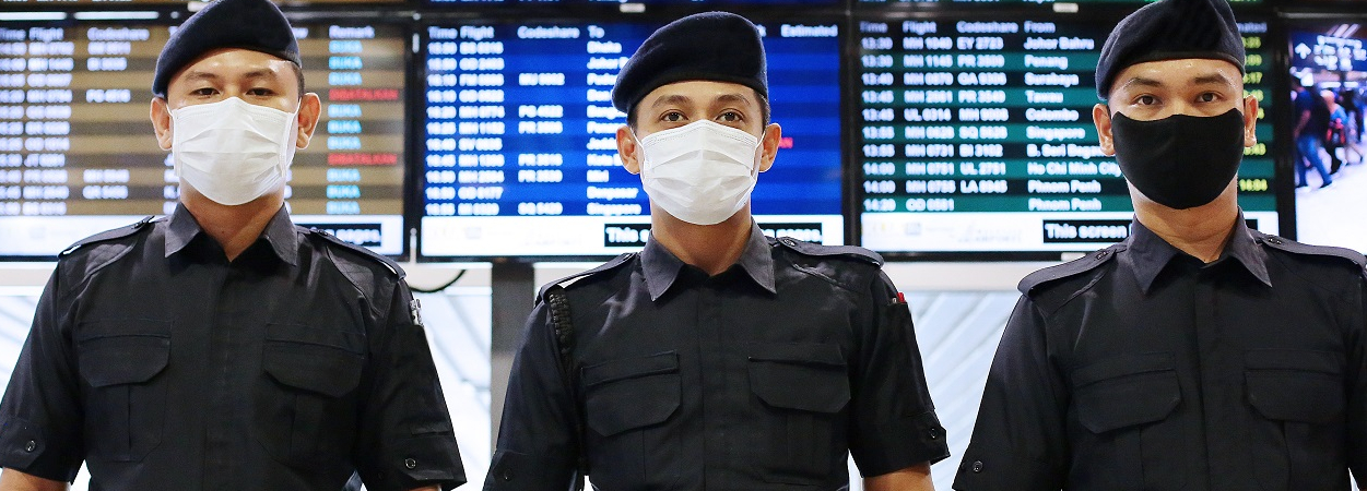Malaysian Police at the Airport - in COVID-19 Masks