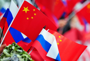Chinese and Russian flags are flying.