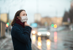 A photograph of a young girl wearing a protective face mask.