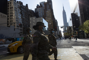 NEW YORK, NY - APRIL 06: U.S Army personnel wearing masks cross 34th street on April 6, 2020 in New York City. The COVID-19 death toll in the U.S. is approaching 10,000.