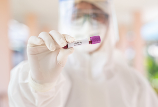 Male doctor holding Covid-19 Blood Sample on White Background