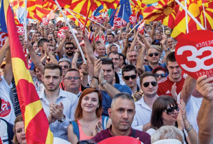 People in Skopje wave the Macedonian and European Union flags at a rally before a referendum in 2018 on whether to change the country's name to "Republic of North Macedonia."