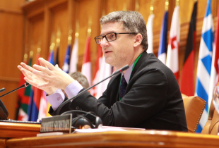 Dr. Mark Galeotti speaking at an event.