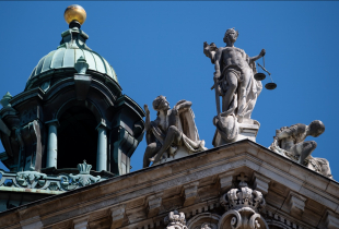 The statue of Justice sits atop the Palace of Justice in Bavaria, Munich.