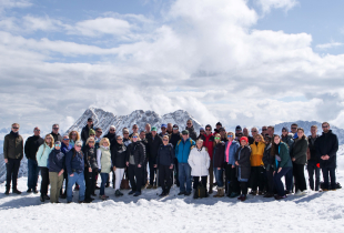 Group of people standing at top of Zugspitze mountain in Germany
