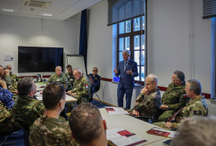 Man presents to uniformed military