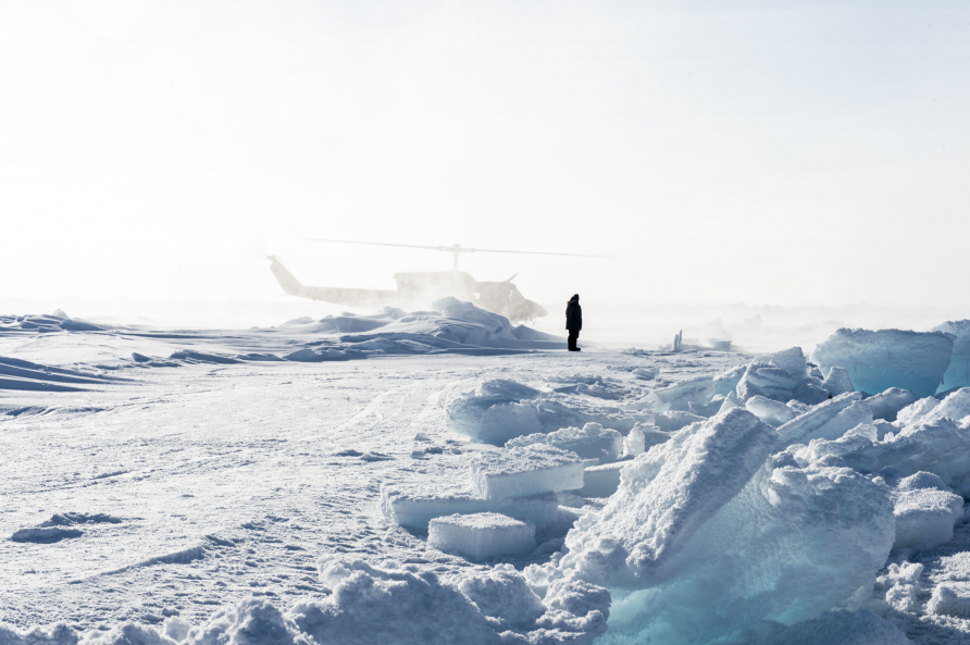 Officer in Tactical Command at Ice Camp Sargo, prepares to greet the Arctic Council before the disembark from a Bell 212 Helicopter during Ice Exercise (ICEX) 2016.