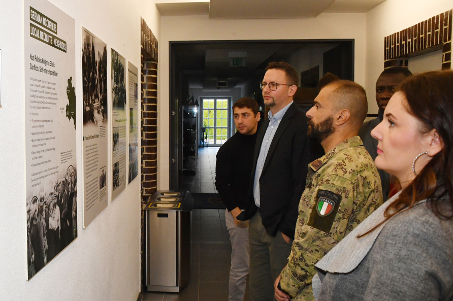 Participants reading through the exhibit on the Holocaust at the Marshall Center.